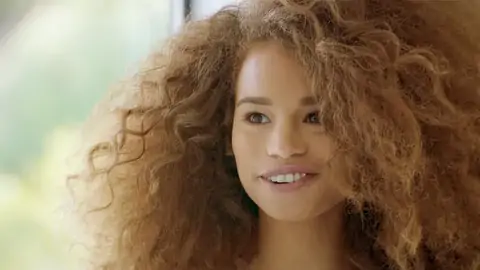 Teenage dark-hued with wavy hair is railing a massive jizz-shotgun on the sofa