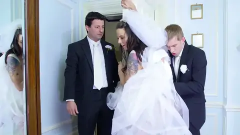 The platinum-light-haired boy is poking a MUMMY in a wedding sundress