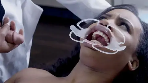 Doctor boinks face of astonished patient in the clinic